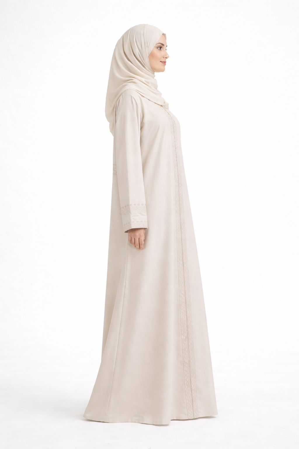 Cream Barbie & Reem style abaya with box collar and embroidered cuffs, side view (model looking ahead).
