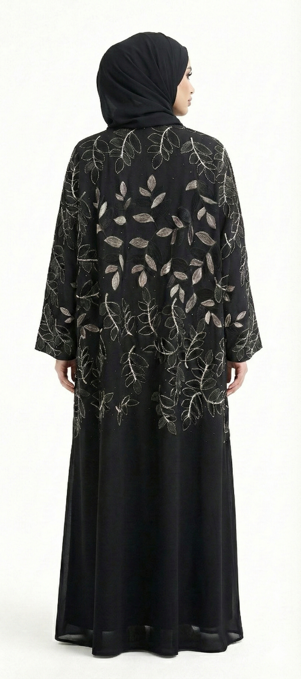 Back view of black abaya featuring gold leaf embroidery with black leaf detailing across the upper back, model wearing black hijab.