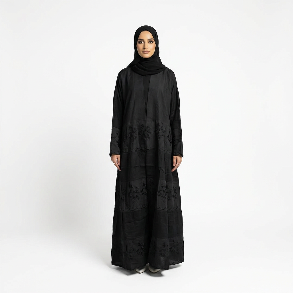 Front view of black Hana layered crepe abaya with subtle black floral embroidery, styled with matching black hijab.