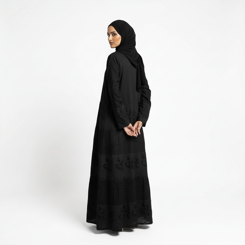 Back three-quarter view of black Hana layered crepe abaya showing length and drape, matching black hijab.