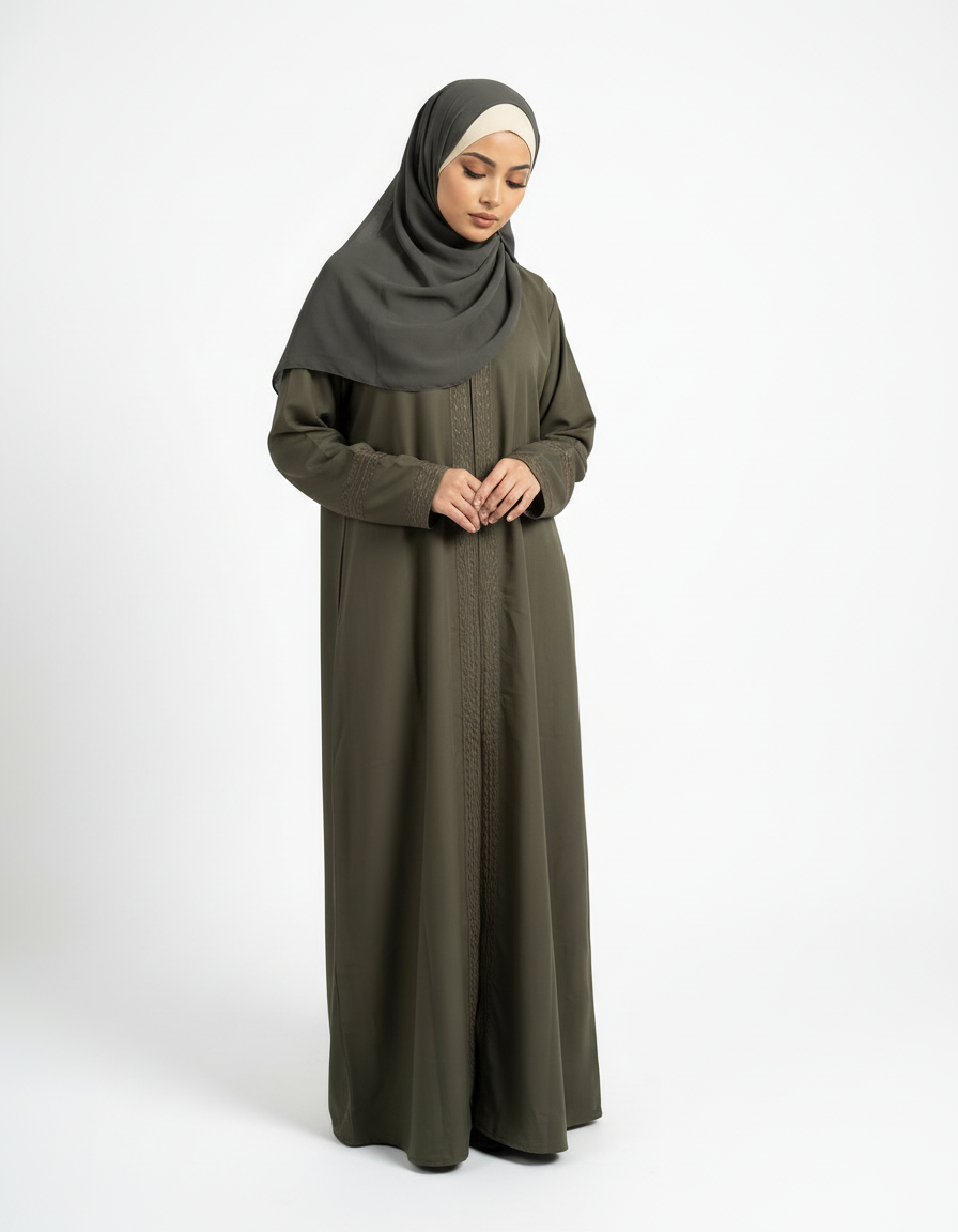 Front view of olive green Barbie & Reem style abaya with box collar and embroidered cuffs, model looking down.