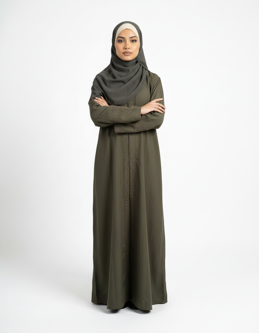 Front view of olive green Barbie & Reem style abaya with arms crossed, showing sleeve and cuff shape.