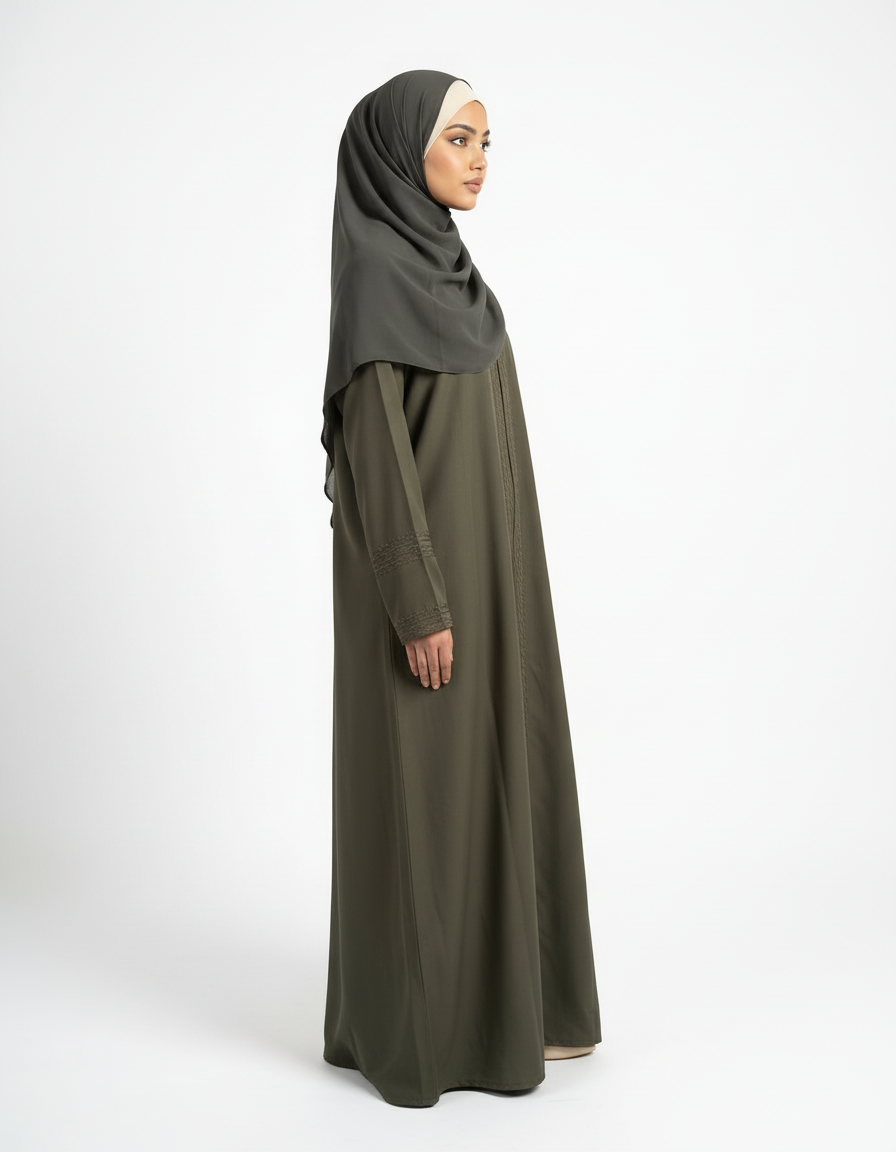 Side profile view of olive green Barbie & Reem style abaya showing flowy drape and full length.