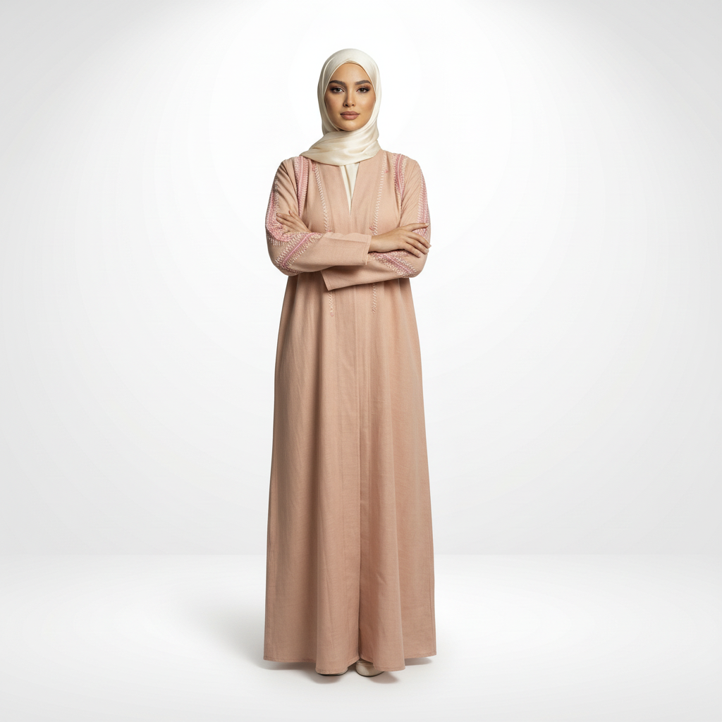 Pink linen embroidered abaya with zigzag detailing, cream hijab, full-length front view (arms crossed).