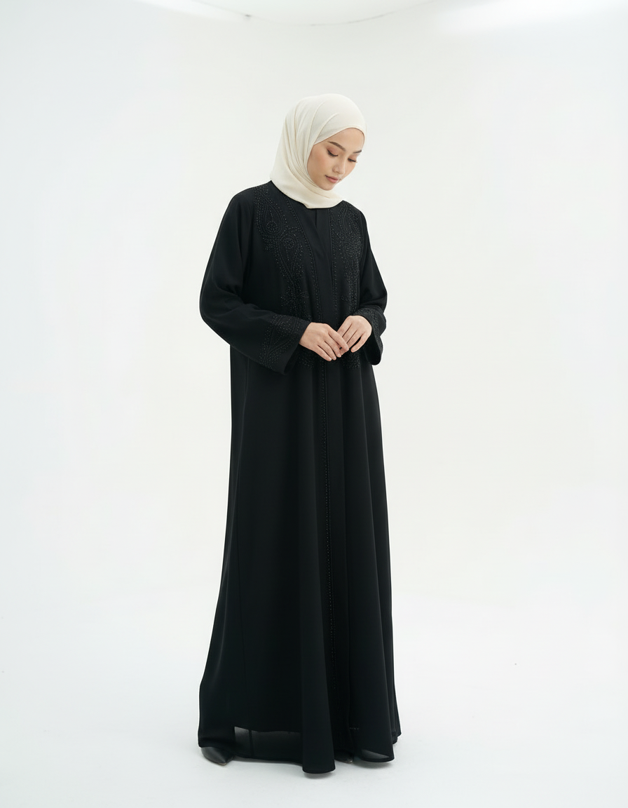 Full-length front view with head slightly lowered, black abaya and cream hijab, studio white background.