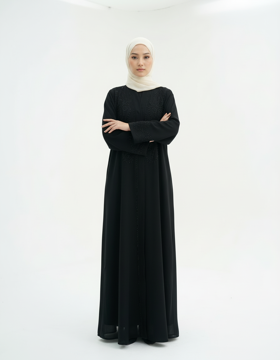 Full-length front view with arms crossed, black abaya and cream hijab, studio white background.