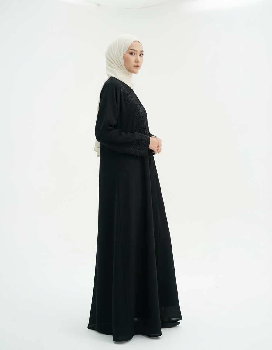 Full-length front view with arms crossed, black abaya and cream hijab, studio white background.