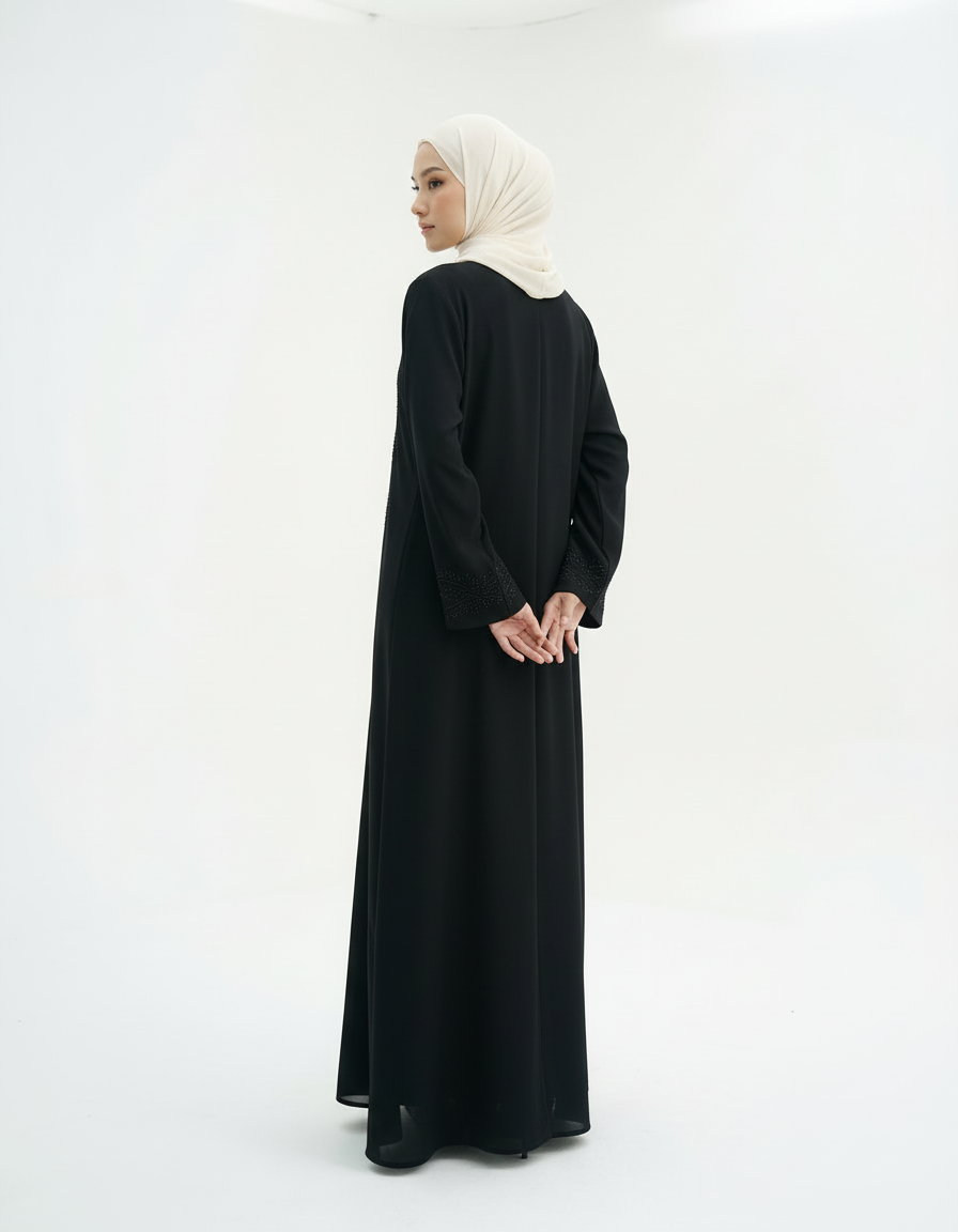 Back view showing full-length fall of the abaya, model in cream hijab, studio white background.