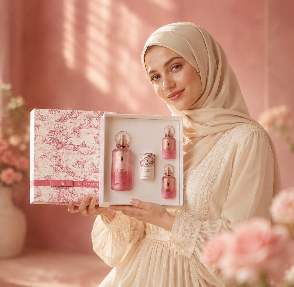 Blonde hijabi woman holding Miss Laverne Extreme luxury perfume gift set in elegant feminine setting.
